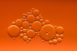 2018 European African HIV/AIDS & Hepatitis C Community Summit picture of bubbles in liquid with an rust coloured hue
