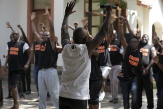 Exercise for mental health wellbeing Sammy Ombisa Recovery Ally & Certified Wellness Coach(in white), Instructing men through exercises. exercises.